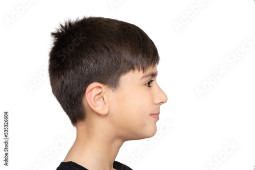 Profile of pretty nice little boy with stylish in T-shirt looking to side with serious attentive face, calm pensive expression. indoor studio shot isolated on white background, copy space