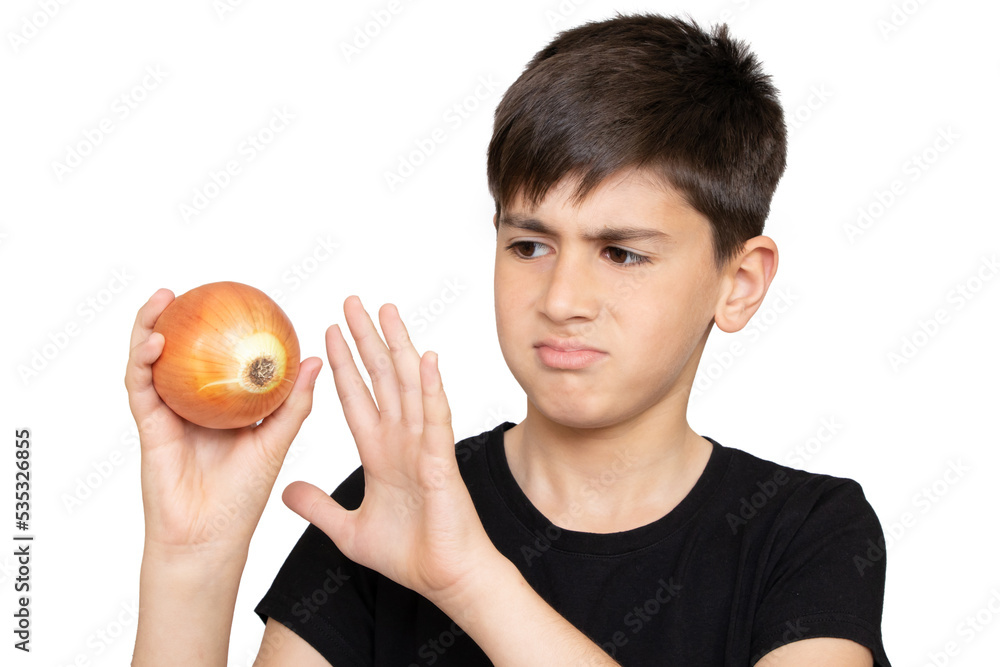 A boy holding onion with disgust. Isolated on the white background A boy holding onion with disgust. Isolated on the white background