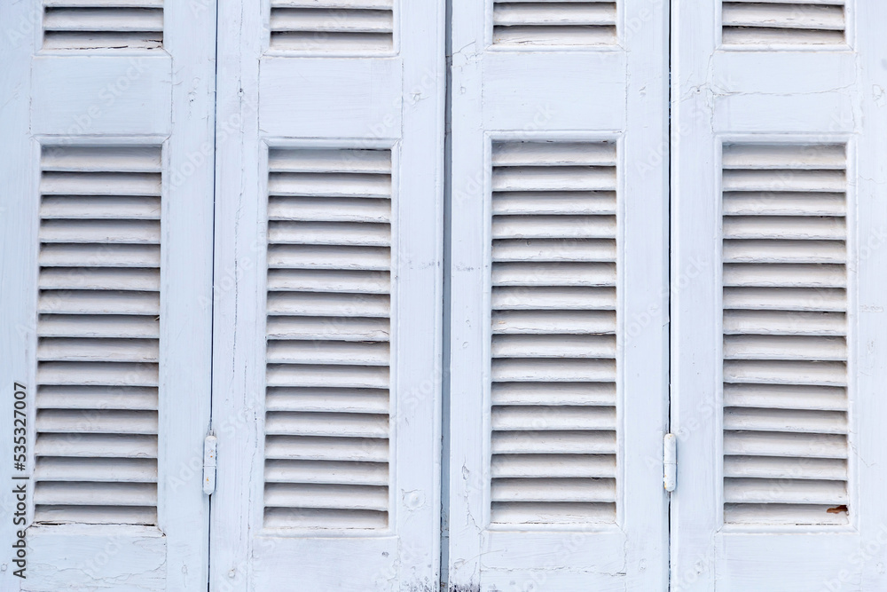 Window closed shutters background, texture. Traditional Greek island house. Window closed shutters background, texture. Traditional Greek island house.