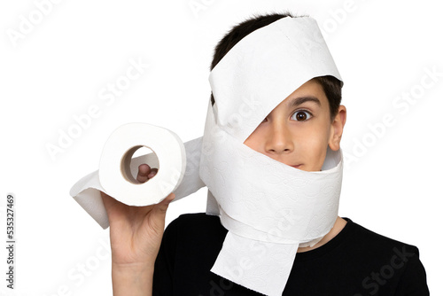 Photo of adorable young happy boy looking at camera. Active boy playing with toilet paper in white background, Child holding White tissue, Children health care concept