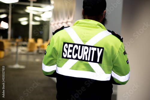 Security guard patrolling office at night.