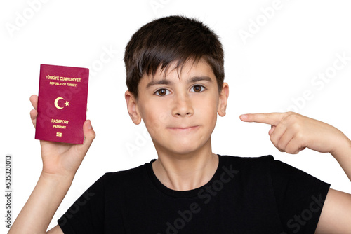 Brunette little boy holding passport of Turkey screaming proud and celebrating victory and success very excited, cheering emotion