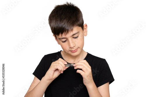 Healthy boy cutting nails using stainless steel nail clipper on the white background. Hygiene. Virus bacteria in nails. Sanitizer hand. Coronavirus covid19.