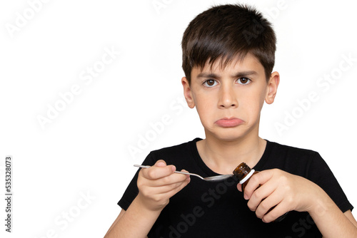 Patient boy takes medicine syrup .Isolated on the white background