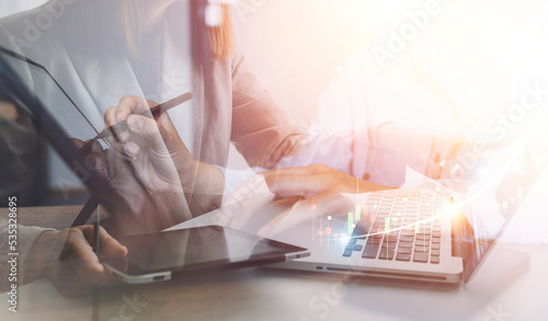 Businessman hands working with finances about cost and calculator and laptop with tablet, smartphone at office in morning light