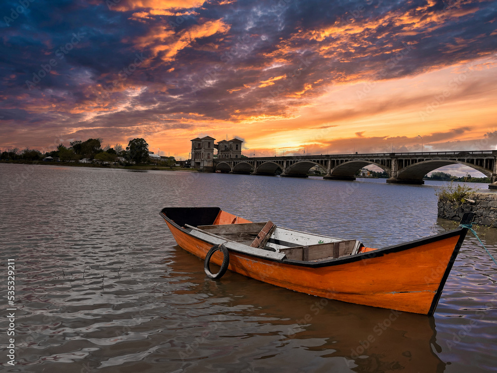 Stormy sunrise over abandoned fishing boats 