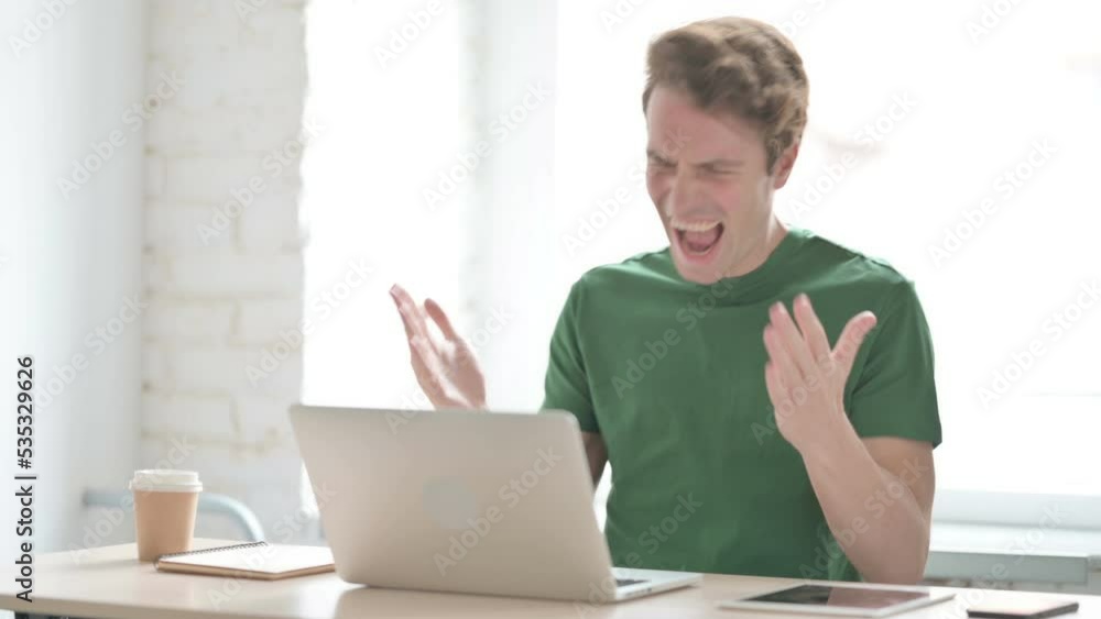 Frustrated Angry Young Man Working on Laptop Frustrated Angry Young Man Working on Laptop