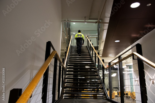 A security guard is patrolling an office at night.