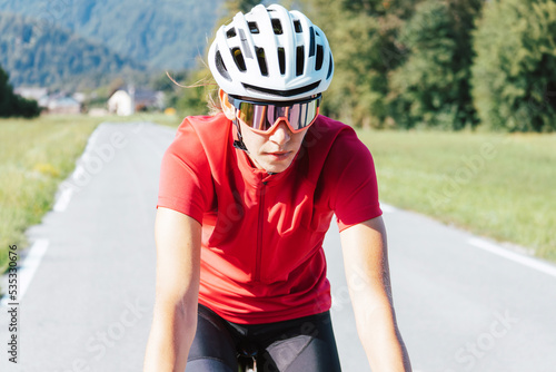 Woman road cycling on race bike outdoor in nature © 24K-Production