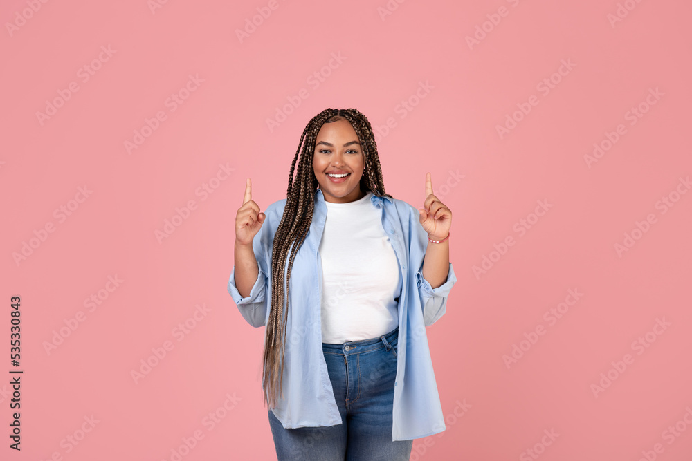 Happy Black Overweight Lady Pointing Fingers Up Over Pink Background Happy Black Overweight Lady Pointing Fingers Up Over Pink Background