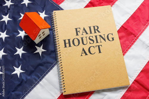 Fair housing act near tiny house on a flag.