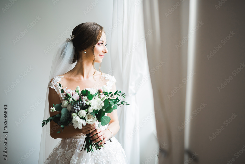 Bride holding big and beautiful wedding bouquet with flowers