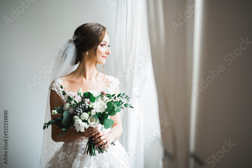Bride holding big and beautiful wedding bouquet with flowers