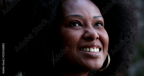 Positive African woman smiling. Black person portrait face close-up