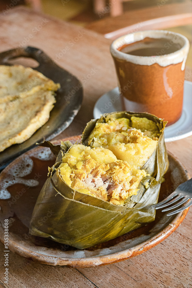 Traditional Colombian tamale made in Santander region isolated on wooden table