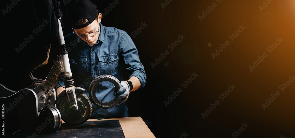 repair of an electric scooter in a workshop, replacement of a tire on a wheel.