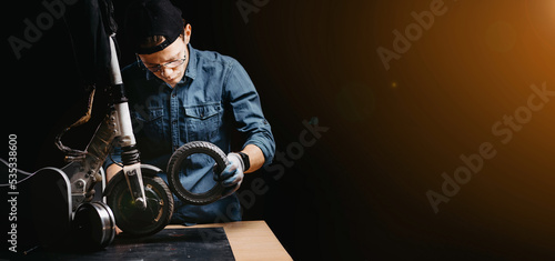 Obraz na płótnie repair of an electric scooter in a workshop, replacement of a tire on a wheel. w salonie