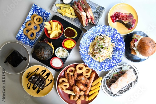 Table scene of assorted take out or delivery foods. Traditional Turkish cuisine. Various Turkish meal and appetizers. Top down view on a table. photo