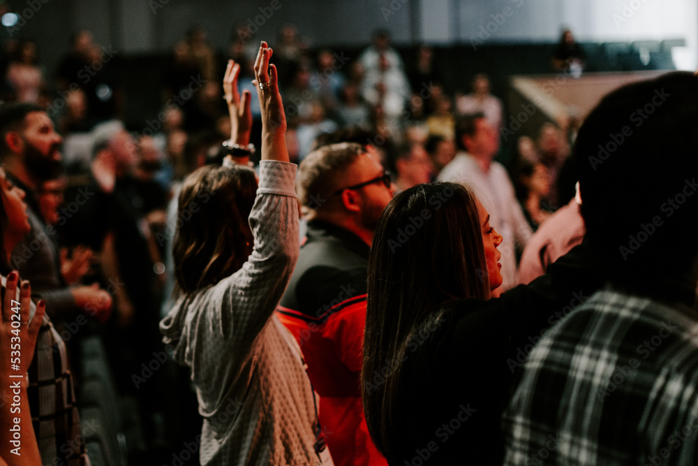 Hands in the air of people who praise God at church service - obrazy, fototapety, plakaty 