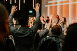 Hands in the air of people who praise God at church service