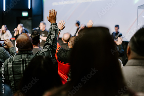 Hands in the air of people who praise God at church service