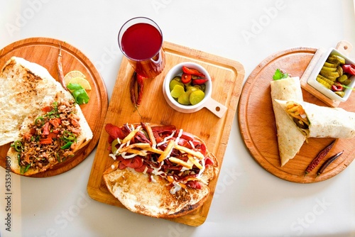 Table scene of assorted take out or delivery foods. Traditional Turkish cuisine. Various Turkish meal and appetizers. Top down view on a table. photo