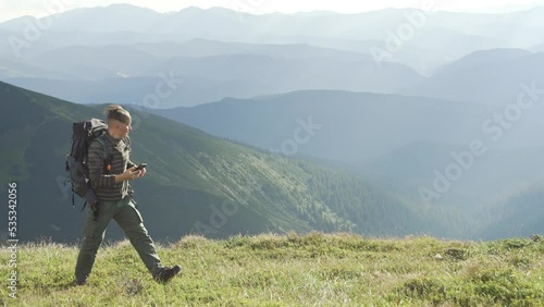 A man is looking for a network on a phone in the mountains, while hiking. A tourist with a smartphone is trying to make a call. There is no cellular connection. High quality 4k footage