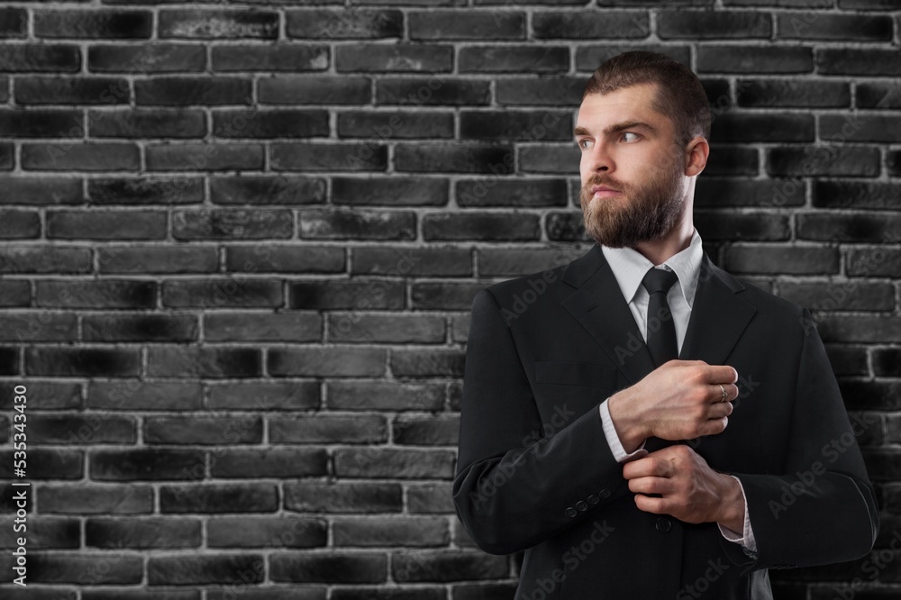 attractive elegant man looking to side, being confident and cool, posing and standing on background attractive elegant man looking to side, being confident and cool, posing and standing on background