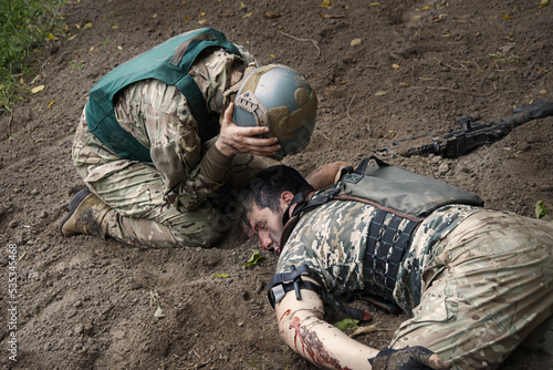 The friend cries at wounded soldier photo