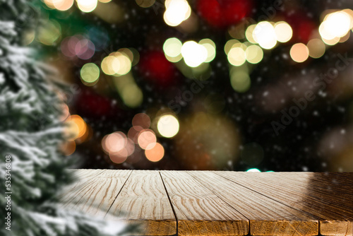 Blurred Christmas background with empty wooden table in focus. Empty display for product assembly