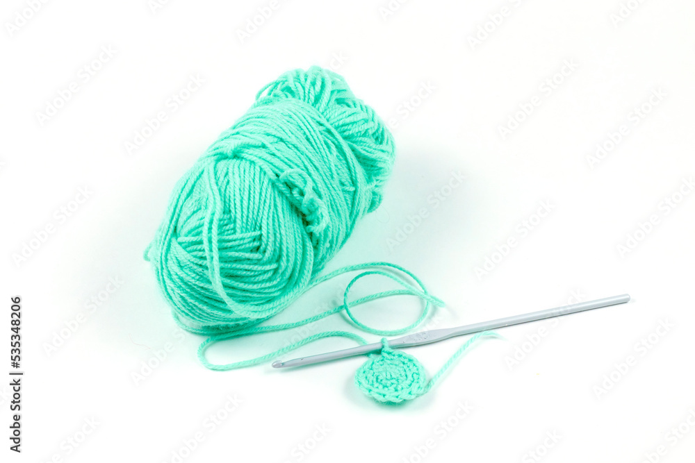 Knitting. Turquoise threads and hook. High quality photo