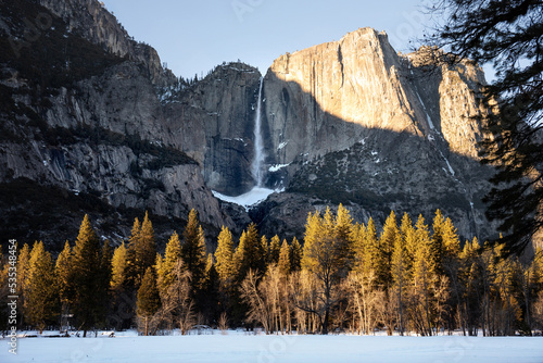 Upper Yosemite Waterfall in winter, landscape with mountains, snow and trees photo