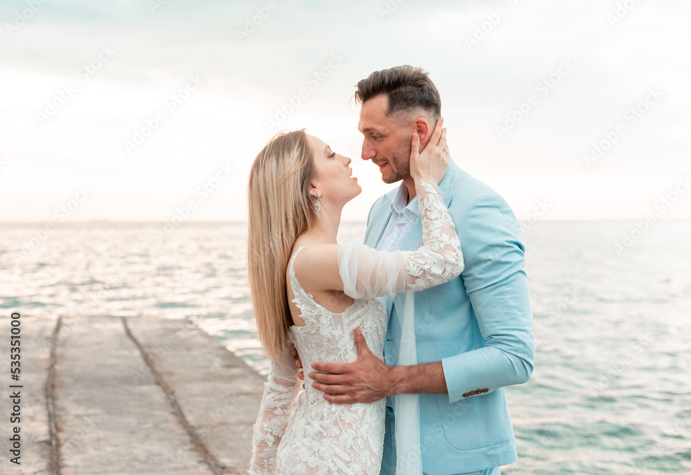 wedding couple, groom and bride in wedding dress near the sea at the seaside wedding couple, groom and bride in wedding dress near the sea at the seaside