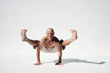 Man practicing perfect yoga photographed against a white background. 