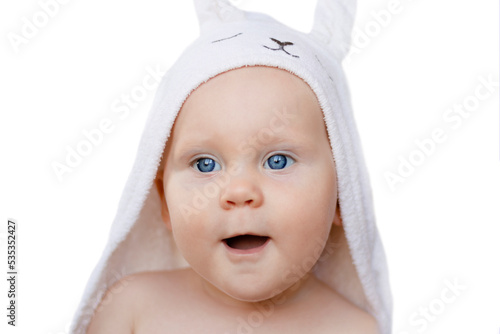 Happy laughing baby wearing white hooded rabbit towel. Portrait of clean dry child. Bathing and washing of little kids. Children hygiene. Textile for infants.