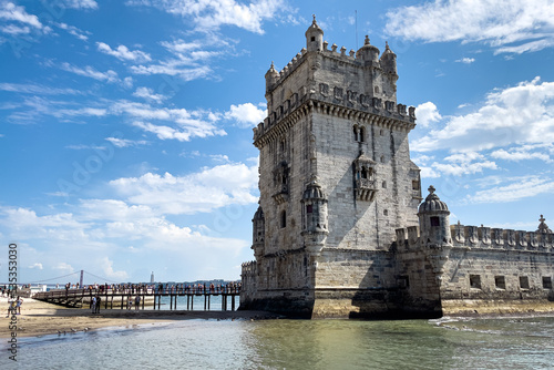 Tourists walking nearby Belem tower in Lisbon