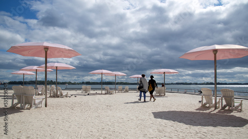 A popular tourist destination in Toronto with pink beach umbrellas and Adirondack chairs