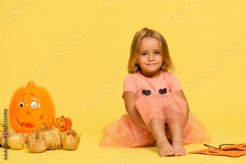 girl looking straight ahead with a halloween sign.Trick or treat