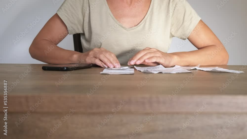Woman with no money for household bills. A woman with financial problems count her bills for electricity and household in the room. Woman with no money for household bills. A woman with financial problems count her bills for electricity and household in the room.