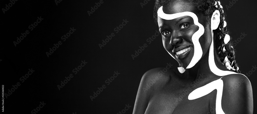The Art Face. Black and white body paint on african woman. Abstract  creative portrait. Bright fashion makeup on the girl. Stock Photo