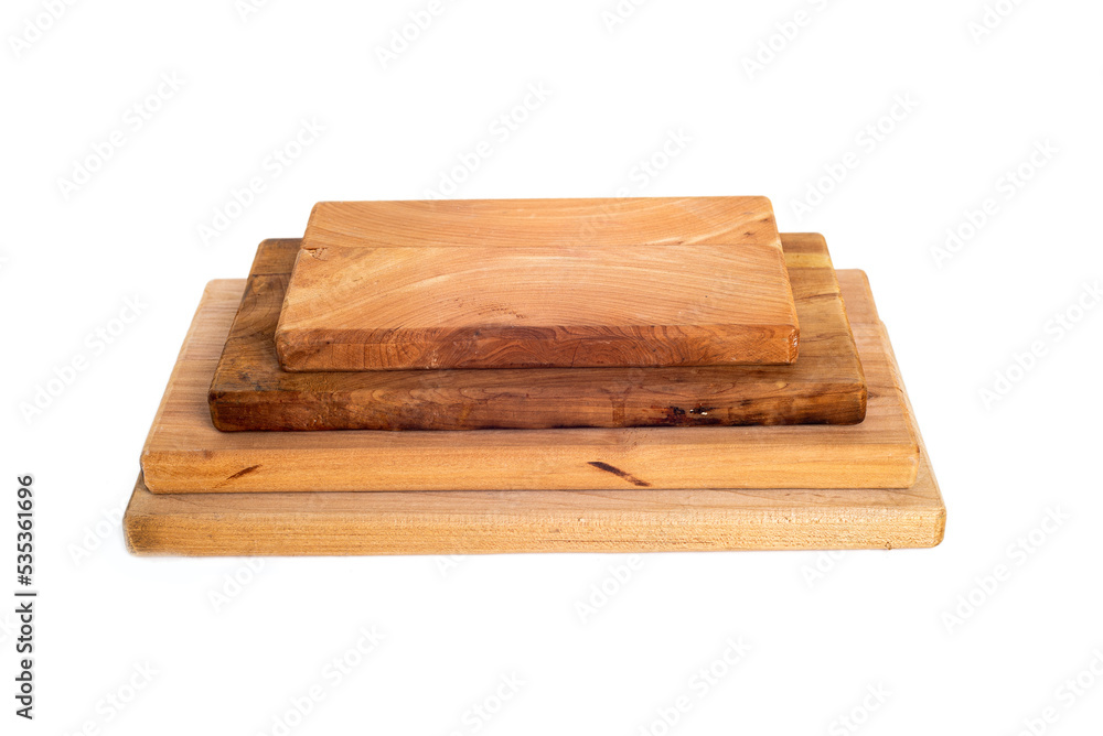 stack of wooden cutting boards of various sizes isolated on white background.