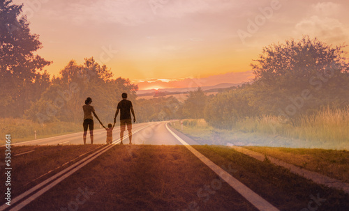 Family looking to the future facing empty country road.  © kieferpix