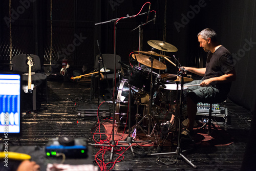 Drummer in rock band recording music in the professional recording studio