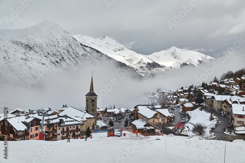 Skiing resort village in fog in the french alps photo