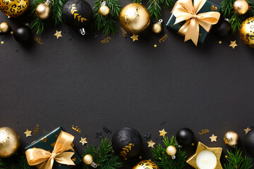 Black Christmas background with luxury decorations, golden balls, gift boxes, fir branches. Xmas banner mockup, Ne Year greeting card template