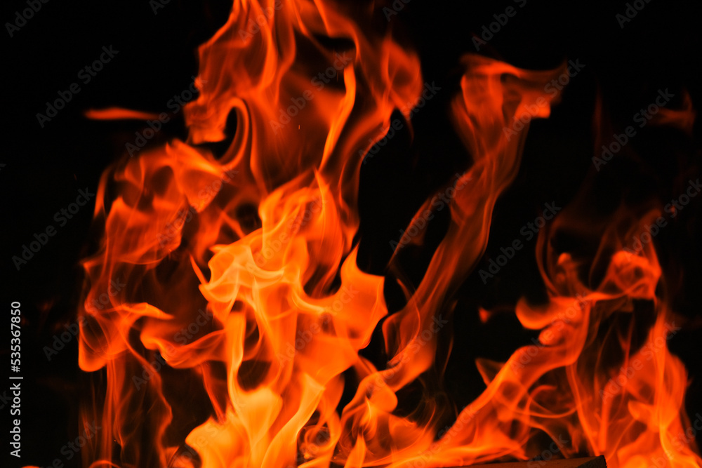  Flames on a black background. Tongues of flame, sparks close-up.fiery wallpaper.Flame. burning in bonfire. 