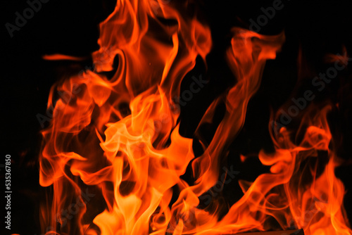  Flames on a black background. Tongues of flame  sparks close-up.fiery wallpaper.Flame. burning in bonfire. 