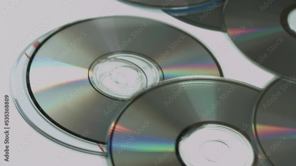 CDs Shine & Reflect On Slowly Rotating White Background CDs Shine & Reflect On Slowly Rotating White Background