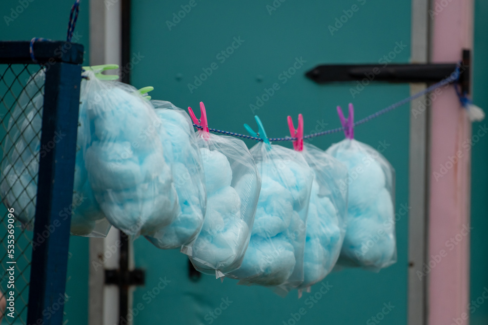 Bags of blue cotton candy in clear plastic bags. The confectionery