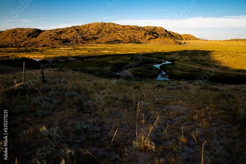 Granite Mountains of Wyoming at dawn with meandering Sweetwater river in the middle ground and sagebrush in the foreground
